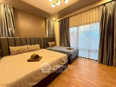 Luxurious bedroom with elegant decor and large windows for natural light.