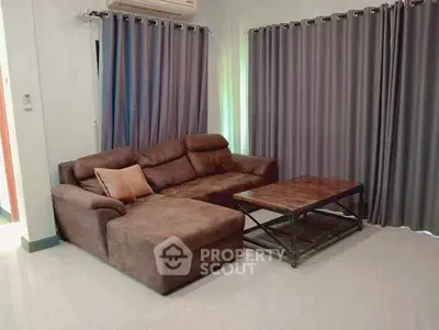 Cozy living room with plush brown sofa and modern coffee table, perfect for relaxation.