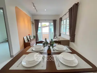 Charming dining area with elegant table setting and natural light in cozy home interior.