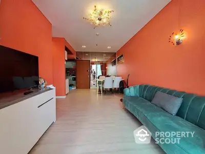 Modern living room with vibrant orange walls and stylish green sofa