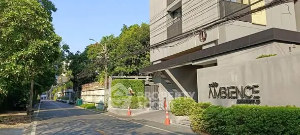 Modern building exterior with lush greenery and street view