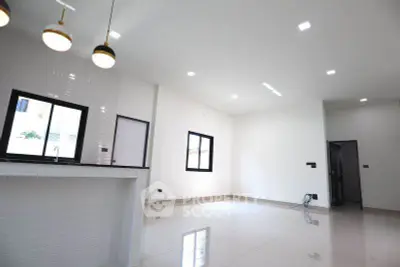 Spacious modern interior with sleek lighting and large windows in a minimalist design.