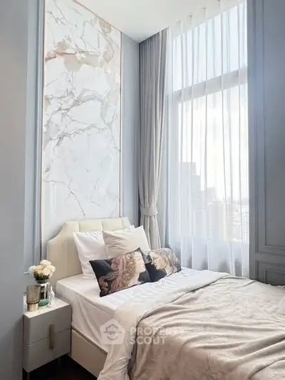 Luxurious bedroom with high ceilings and elegant decor in a modern apartment.