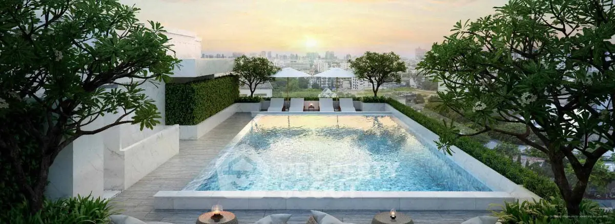 Luxurious rooftop pool with stunning city views and lush greenery, perfect for relaxation and leisure.