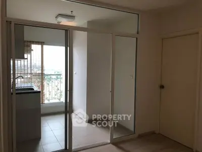 Modern apartment with glass doors leading to a balcony offering a scenic view.