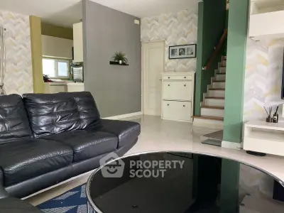 Stylish living room with modern black leather sofas and chic decor