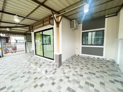 Spacious covered patio with modern tiles and sliding glass doors in a contemporary home.