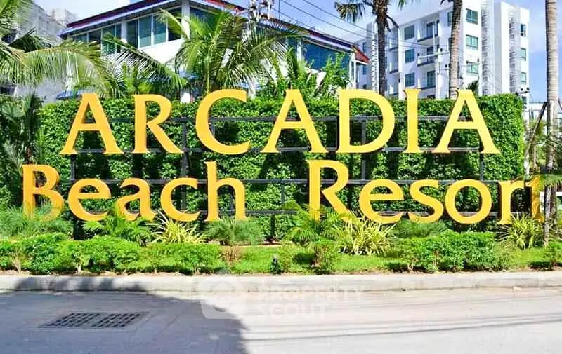 Arcadia Beach Resort entrance with lush greenery and modern architecture.
