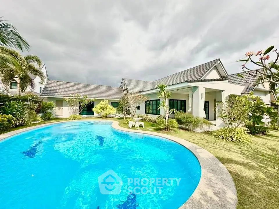 Luxurious villa with stunning pool and lush garden, perfect for serene living.