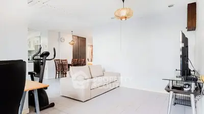 Spacious living room with modern decor and exercise equipment