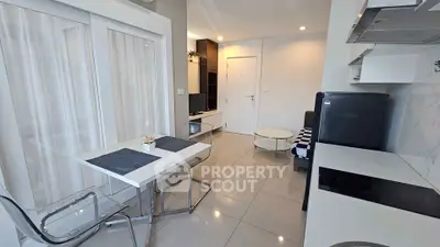 Modern open-layout kitchen and living area with sleek design and natural light.