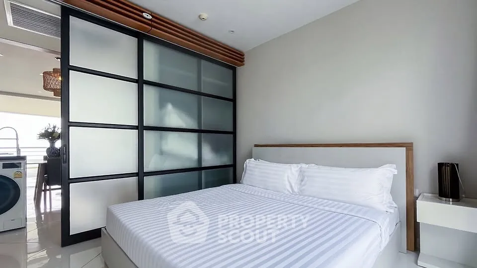 Modern bedroom with sliding glass doors and minimalist decor