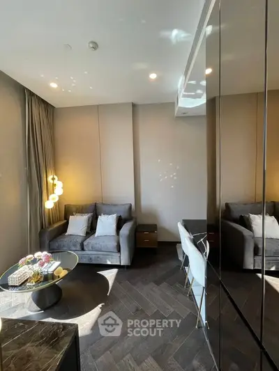 Modern living room with stylish furniture and elegant lighting, featuring a cozy sofa and chic decor.