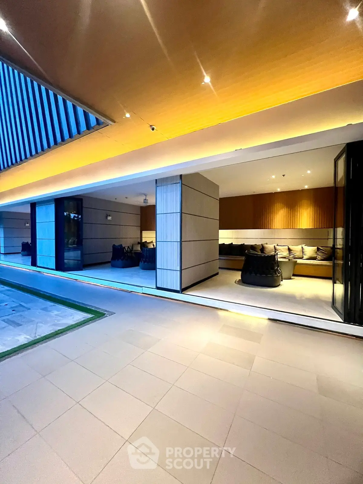 Luxurious modern building entrance with sleek design and ambient lighting