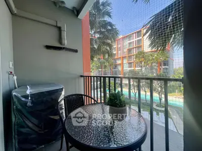Charming balcony with pool view, perfect for relaxation and outdoor dining.