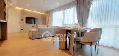 Spacious modern living room with dining area and large windows in a stylish apartment.