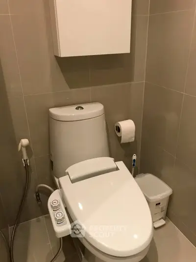 Modern bathroom with smart toilet and sleek design, featuring a bidet and storage cabinet.