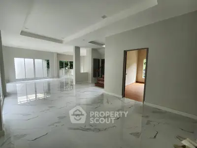 Spacious modern living room with marble flooring and natural light