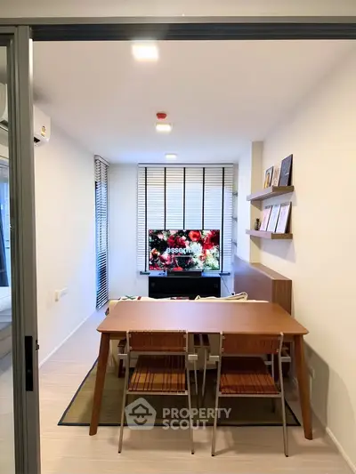 Modern living room with stylish furniture and large TV, perfect for cozy gatherings.