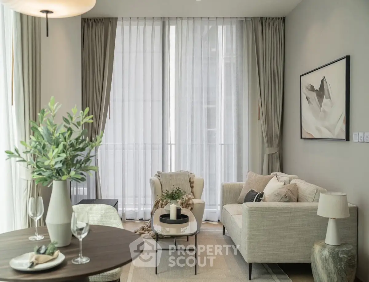 Elegant living room with modern decor and large windows