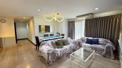 Spacious living room with elegant decor and ample natural light in a modern apartment.