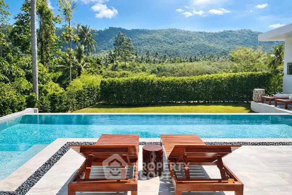 Luxurious villa with stunning pool and mountain view, perfect for relaxation and tropical living.