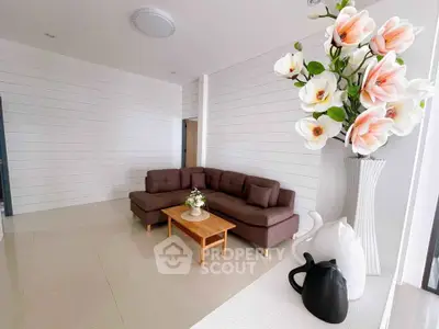 Modern living room with stylish sectional sofa and elegant floral decor