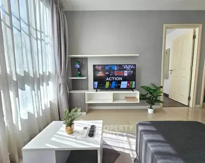 Modern living room with sleek TV setup and natural light