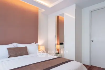 Elegant bedroom with modern design and cozy lighting in a stylish apartment.