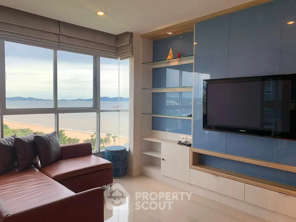 Luxurious living room with stunning ocean view and modern entertainment setup.
