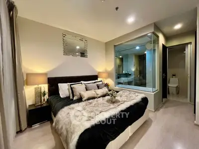 Luxurious bedroom with modern decor and ensuite bathroom in upscale apartment