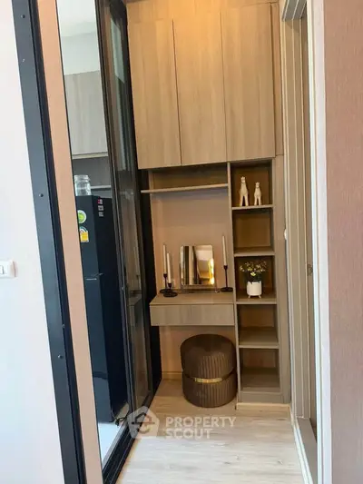 Chic modern storage area with elegant decor and ample shelving in a stylish apartment.