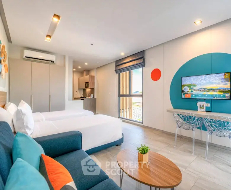 Modern studio apartment with stylish decor, featuring a cozy living area and open kitchen layout.