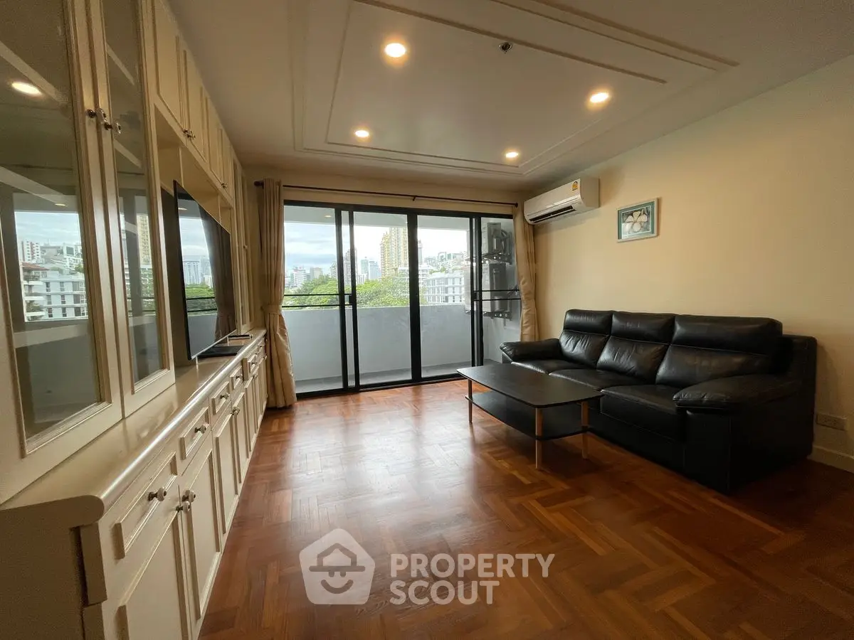 Spacious living room with city view and elegant wooden flooring