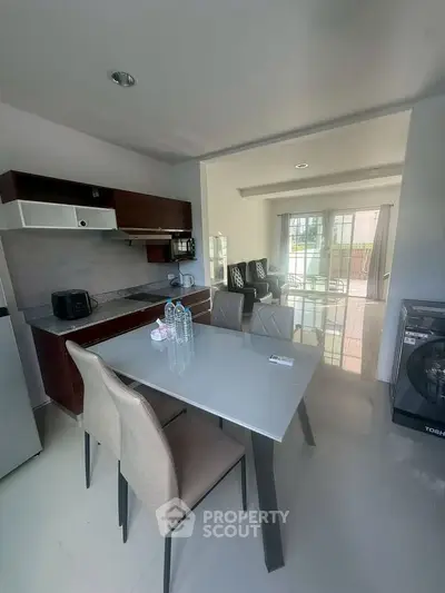 Modern kitchen with dining area and sleek appliances in open layout
