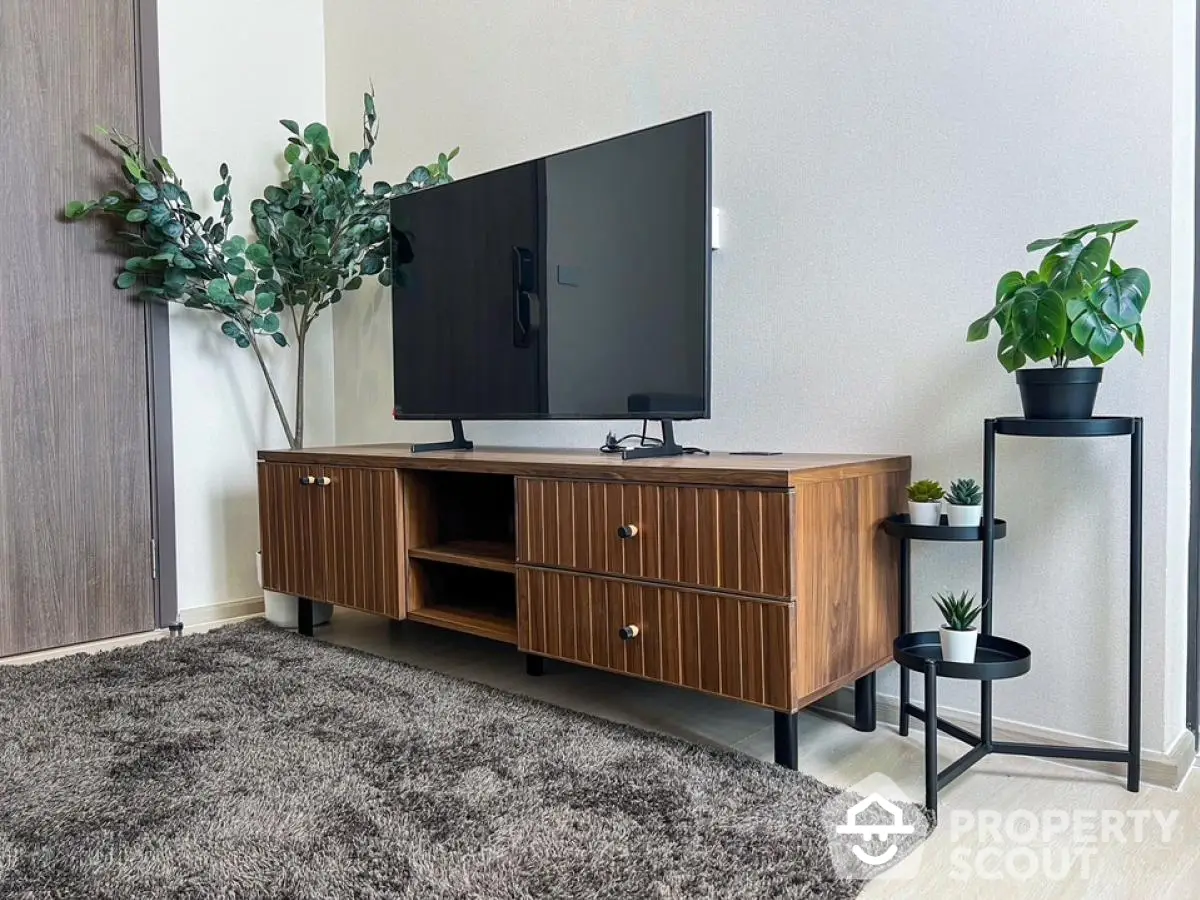 Modern living room with stylish wooden TV stand and lush green plants