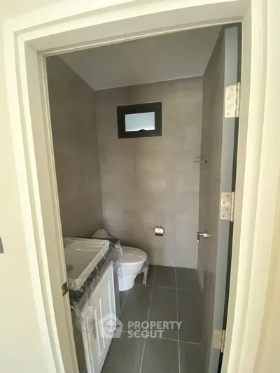 Compact modern bathroom with sleek design and neutral tones