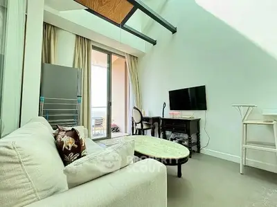 Modern living room with high ceiling and balcony access