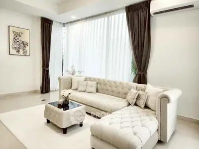 Elegant living room with plush sectional sofa and large windows