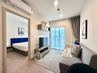 Modern apartment living room with cozy decor and bedroom view