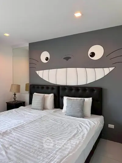Charming bedroom with unique wall art and cozy twin beds, perfect for a playful and inviting atmosphere.