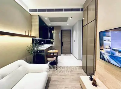Modern living room with open kitchen, sleek design, and cozy ambiance