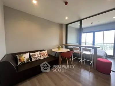 Modern living room with stylish decor and balcony view