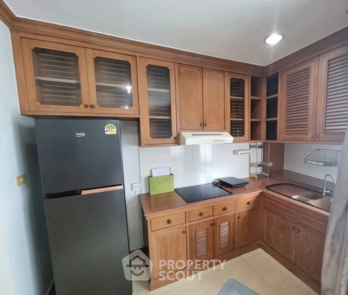 Charming kitchen with wooden cabinets and modern appliances in cozy apartment