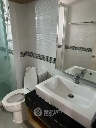 Modern bathroom with sleek fixtures and glass shower enclosure