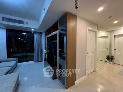 Modern living room with sleek design and large windows offering city views.