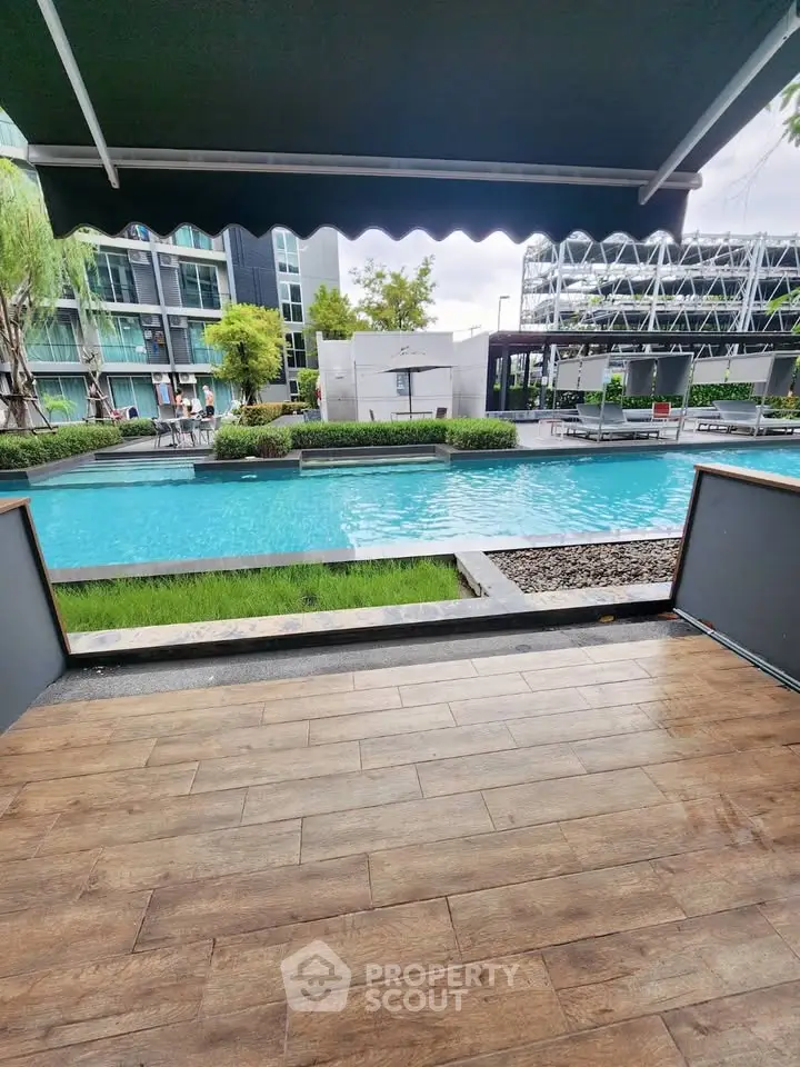 Luxurious poolside view with modern architecture and lush greenery, perfect for relaxation and leisure.