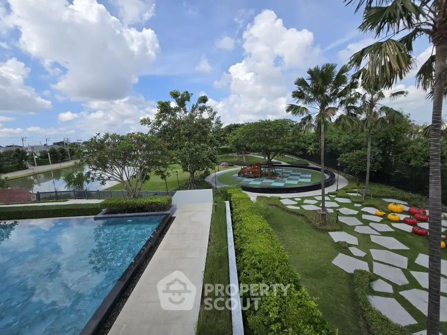 Luxurious outdoor pool area with lush garden and scenic view
