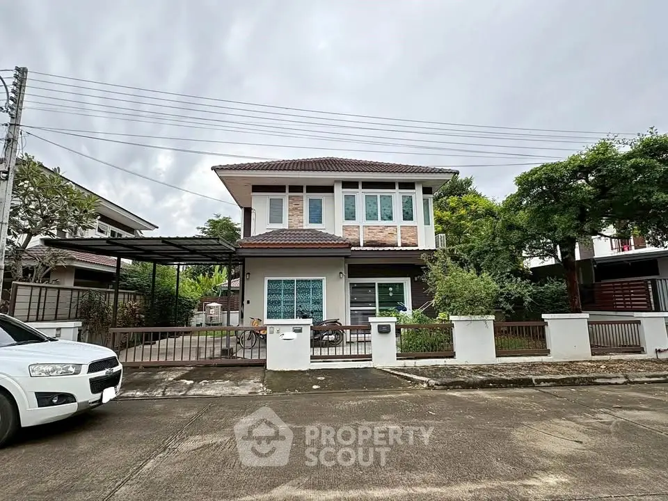 Charming two-story house with modern design and spacious driveway in a serene neighborhood.