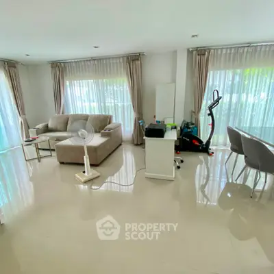 Spacious living room with modern furniture and large windows for natural light.